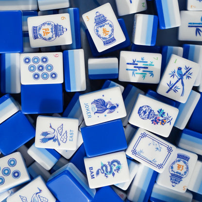 Full tile face layout of the Chinoiserie Porcelain American Mahjong set , displaying ginger jar characters, crane winds, fish jokers, and the cobalt blue triple-layer backing.
