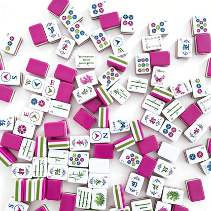 A jumbled close-up view of the Enchanted Butterfly Garden American Mahjong tiles, highlighting the solid olive green and berry magenta layered core alongside butterfly jokers.