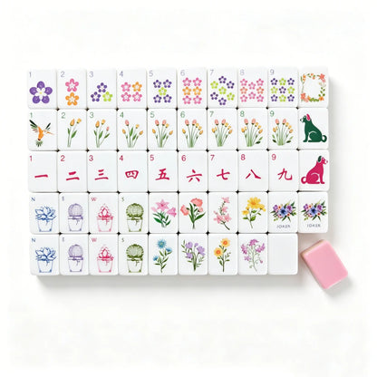 A close-up jumbled view of the Botanical Backyard American Mahjong tiles from the second image, highlighting the solid sage green and pastel pink layered sandwich core alongside hand-painted tulip and flower details.