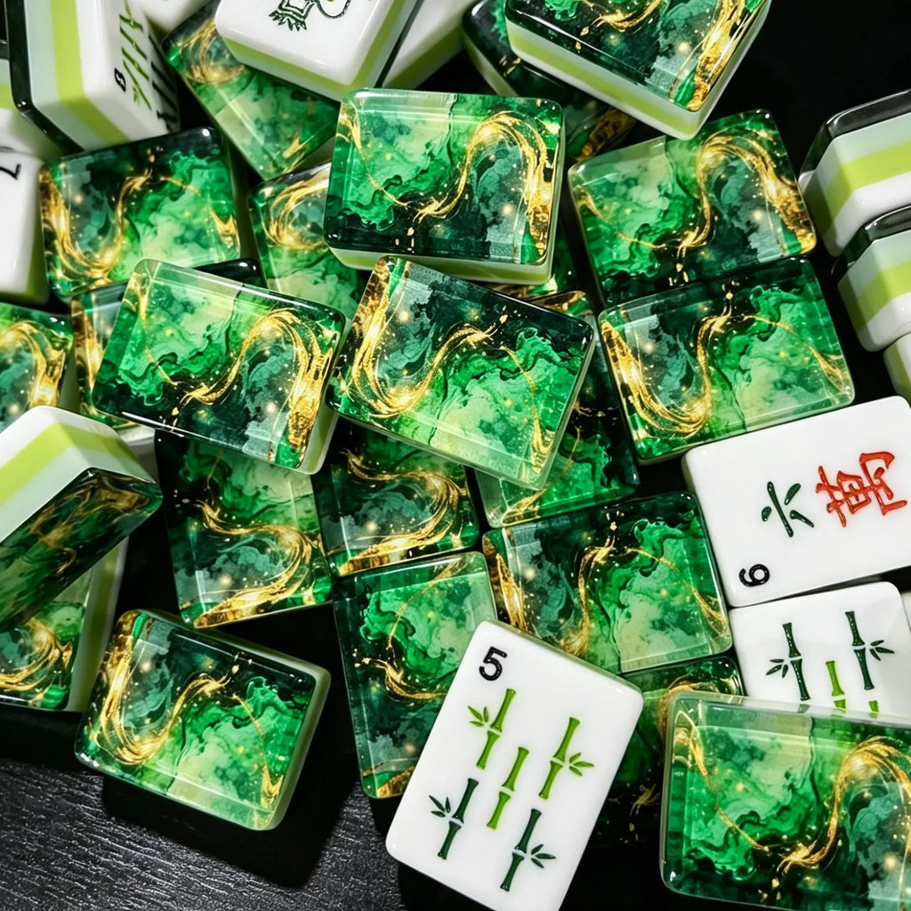 A close-up jumbled view of the American Mahjong tiles, highlighting the premium translucent layer sealing the fluid green ripples and shimmering gold-leaf veins next to a fresh green sandwich core.