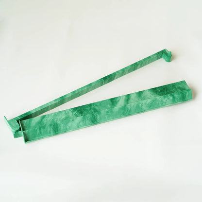 Close-up of a single jade green mahjong rack showing the built-in attached pusher extended for wall sliding.