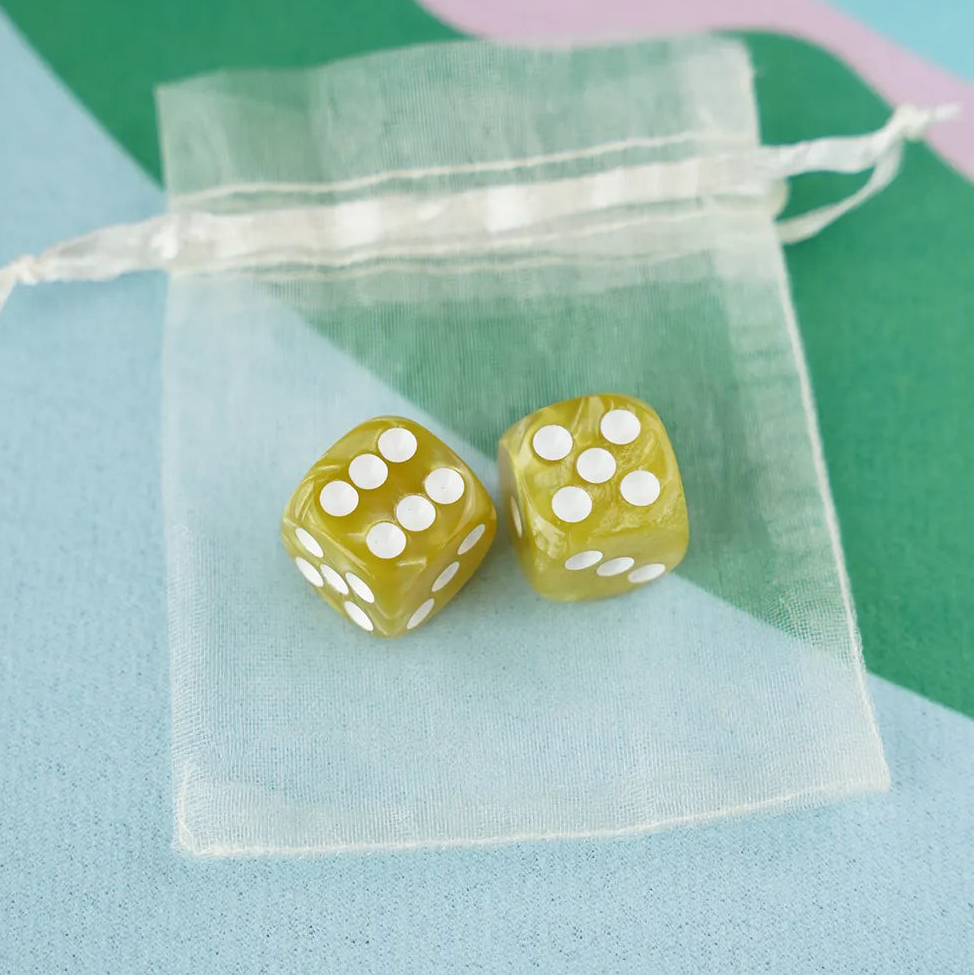 A pair of olive green 5/8 inch marbled acrylic mahjong dice with white pips in a sheer organza pouch.