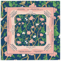 A 31.5-inch square American Mahjong mat in navy blue, featuring a vintage floral bird and green pear pattern with a soft pink Charleston guide border.