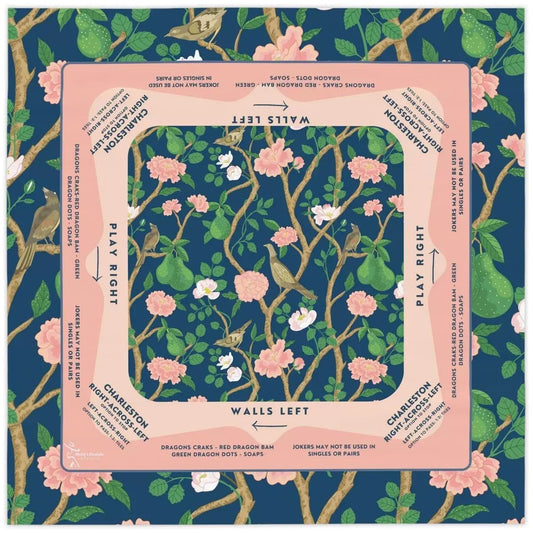 A 31.5-inch square American Mahjong mat in navy blue, featuring a vintage floral bird and green pear pattern with a soft pink Charleston guide border.