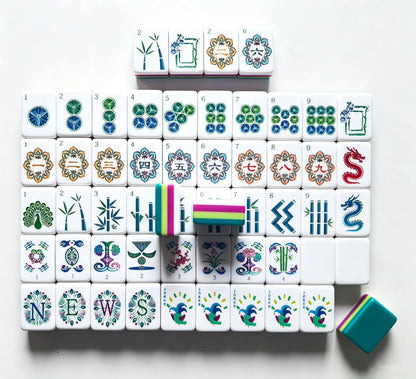 Full tile layout of the Peacock Plume American Mahjong set, showcasing the hot pink and lime green multi-layer core, peacock jokers, and solid teal backing.