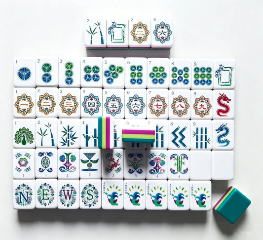 Full tile layout of the Peacock Plume American Mahjong set, showcasing the hot pink and lime green multi-layer core, peacock jokers, and solid teal backing.