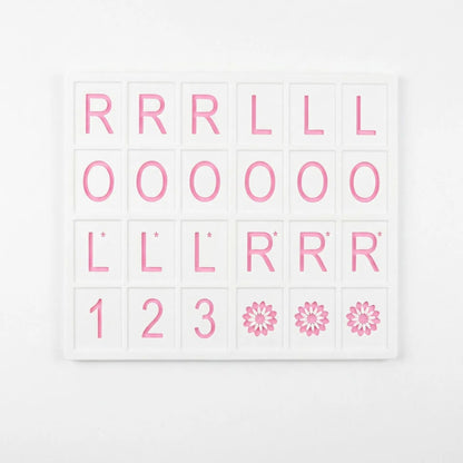 A pink and white 3D printed American Mahjong practice board with a grid layout for organizing tiles and planning Charleston passes.